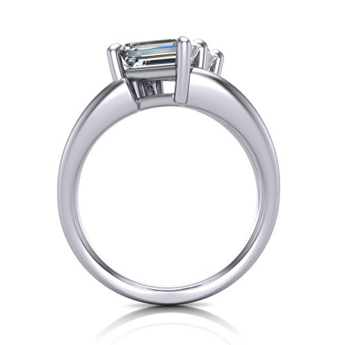 Michelle emerald three stone engagement ring in Platinum, through-finger front profile showing the two-stone head raised above the open split band