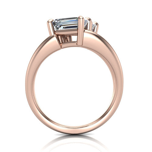 Michelle emerald three stone engagement ring in 14K Rose Gold, through-finger front profile showing the two-stone head raised above the open split band