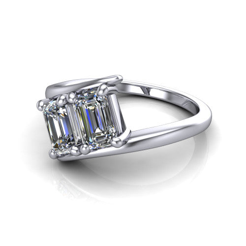 Alayna emerald three stone engagement ring in 18K White Gold, three-quarter perspective showing two diamonds set diagonally in claw baskets on a polished bypass swirl shank