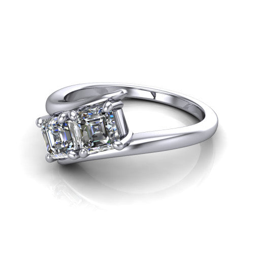 Alayna asscher three stone engagement ring in Platinum, three-quarter perspective showing two diamonds set diagonally in claw baskets on a polished bypass swirl shank