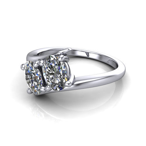 Alayna oval three stone engagement ring in Platinum, three-quarter perspective showing two diamonds set diagonally in claw baskets on a polished bypass swirl shank