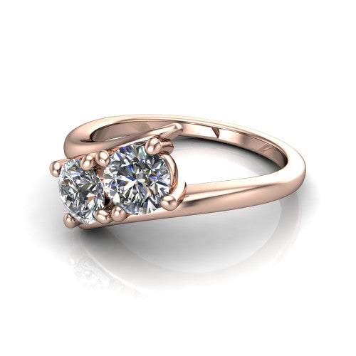 Alayna round three stone engagement ring in 18K Rose Gold, three-quarter perspective showing two diamonds set diagonally in claw baskets on a polished bypass swirl shank