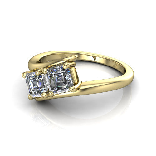 Alayna asscher three stone engagement ring in 14K Yellow Gold, three-quarter perspective showing two diamonds set diagonally in claw baskets on a polished bypass swirl shank
