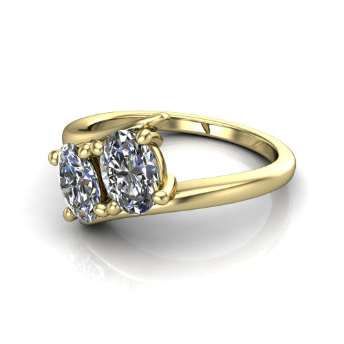 Alayna oval three stone engagement ring in 18K Yellow Gold, three-quarter perspective showing two diamonds set diagonally in claw baskets on a polished bypass swirl shank