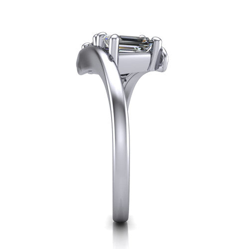 Alayna emerald three stone engagement ring in Platinum, side profile showing the bypass swirl shoulders crossing beneath the two-stone head