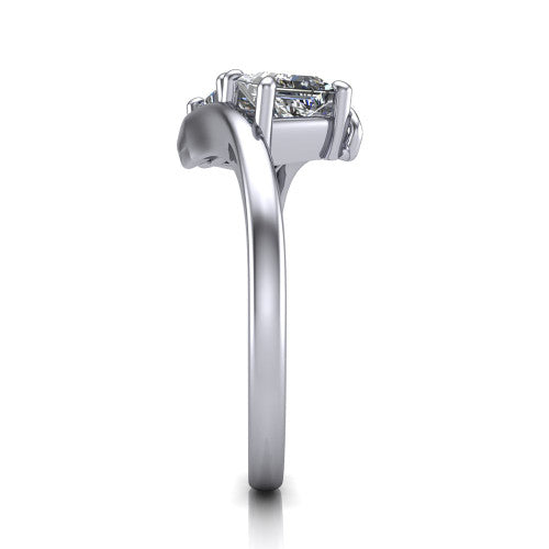 Alayna princess three stone engagement ring in 18K White Gold, side profile showing the bypass swirl shoulders crossing beneath the two-stone head