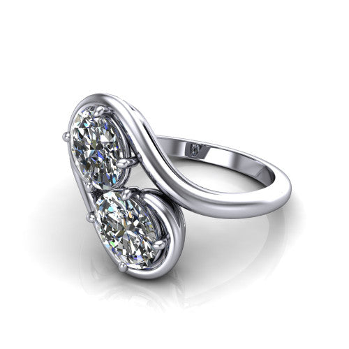 Daniela oval three stone engagement ring in 18K White Gold, three-quarter perspective showing two oval cut diamonds half-bezel set diagonally on a polished bypass shank