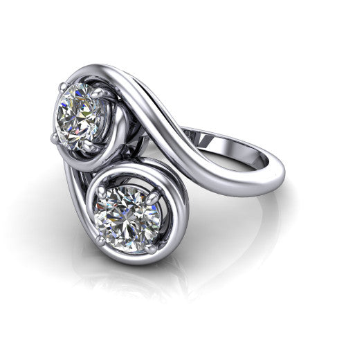Daniela round three stone engagement ring in Platinum, three-quarter perspective showing two brilliant round diamonds half-bezel set diagonally on a polished bypass shank