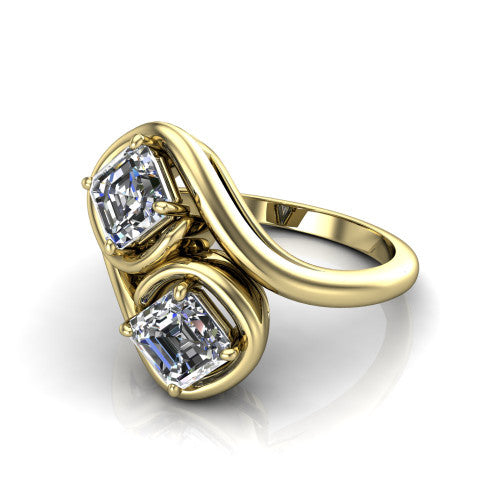 Daniela asscher three stone engagement ring in 14K Yellow Gold, three-quarter perspective showing two asscher cut diamonds half-bezel set diagonally on a polished bypass shank
