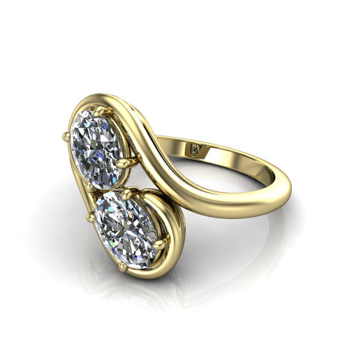 Daniela oval three stone engagement ring in 18K Yellow Gold, three-quarter perspective showing two oval cut diamonds half-bezel set diagonally on a polished bypass shank