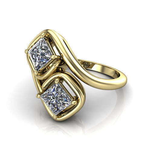 Daniela princess three stone engagement ring in 18K Yellow Gold, three-quarter perspective showing two princess cut diamonds half-bezel set diagonally on a polished bypass shank