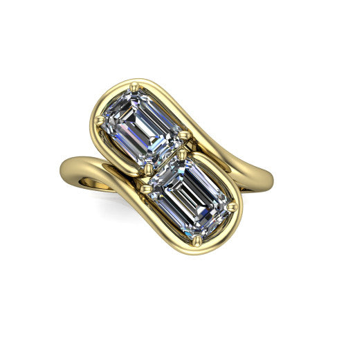 Daniela emerald three stone engagement ring in 14K Yellow Gold, top-down view showing two emerald cut diamonds set diagonally in a toi et moi arrangement within protective half-bezels