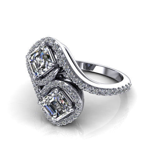 Jane asscher three stone engagement ring in 18K White Gold, three-quarter perspective showing two asscher cut diamonds set diagonally in twin square halos on a pave wraparound shank with bypass swirling shoulders