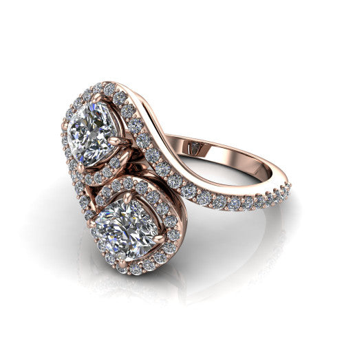 Jane cushion three stone engagement ring in 14K Rose Gold, three-quarter perspective showing two cushion cut diamonds set diagonally in twin square halos on a pave wraparound shank with bypass swirling shoulders