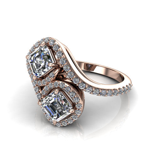 Jane asscher three stone engagement ring in 18K Rose Gold, three-quarter perspective showing two asscher cut diamonds set diagonally in twin square halos on a pave wraparound shank with bypass swirling shoulders