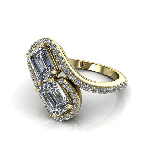 Jane emerald three stone engagement ring in 14K Yellow Gold, three-quarter perspective showing two emerald cut diamonds set diagonally in twin square halos on a pave wraparound shank with bypass swirling shoulders