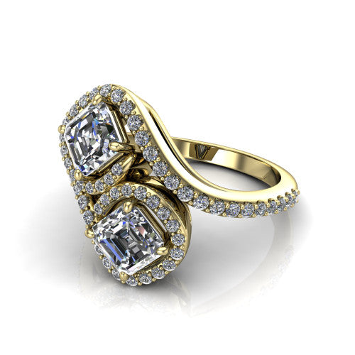 Jane asscher three stone engagement ring in 18K Yellow Gold, three-quarter perspective showing two asscher cut diamonds set diagonally in twin square halos on a pave wraparound shank with bypass swirling shoulders