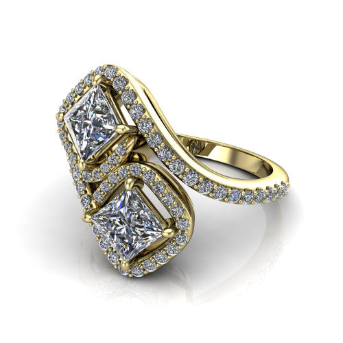 Jane princess three stone engagement ring in 18K Yellow Gold, three-quarter perspective showing two princess cut diamonds set diagonally in twin square halos on a pave wraparound shank with bypass swirling shoulders