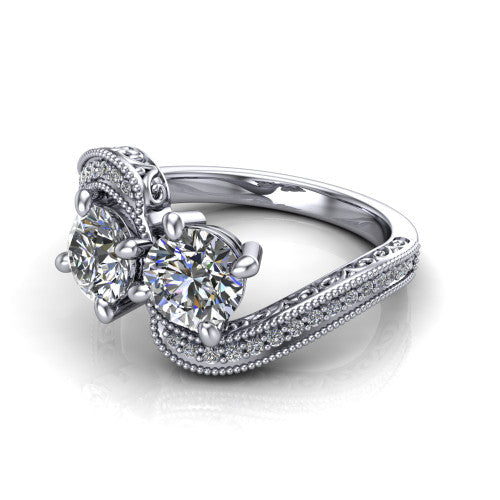 Stevie round three stone engagement ring in 14K White Gold, three-quarter perspective showing two brilliant round diamonds set diagonally on filigree shoulders with milgrain edges and a pave center band