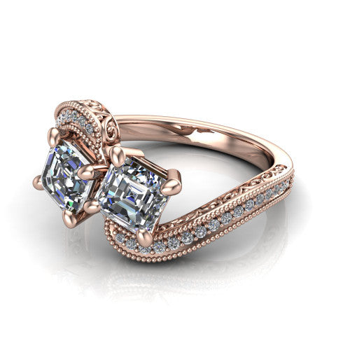 Stevie square emerald three stone engagement ring in 18K Rose Gold, three-quarter perspective showing two step-cut square emerald diamonds set diagonally on filigree shoulders with milgrain edges and a pave center band