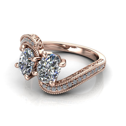 Stevie oval three stone engagement ring in 14K Rose Gold, three-quarter perspective showing two brilliant oval diamonds set diagonally on filigree shoulders with milgrain edges and a pave center band
