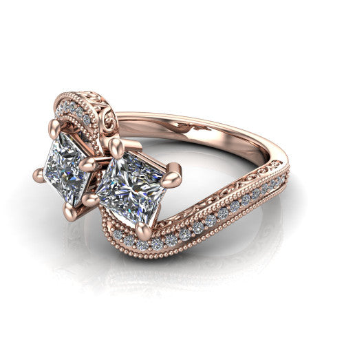 Stevie princess three stone engagement ring in 14K Rose Gold, three-quarter perspective showing two brilliant princess-cut diamonds set diagonally on filigree shoulders with milgrain edges and a pave center band