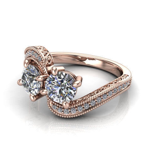 Stevie round three stone engagement ring in 18K Rose Gold, three-quarter perspective showing two brilliant round diamonds set diagonally on filigree shoulders with milgrain edges and a pave center band