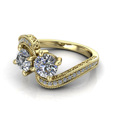 Stevie round three stone engagement ring in 14K Yellow Gold, three-quarter perspective showing two brilliant round diamonds set diagonally on filigree shoulders with milgrain edges and a pave center band