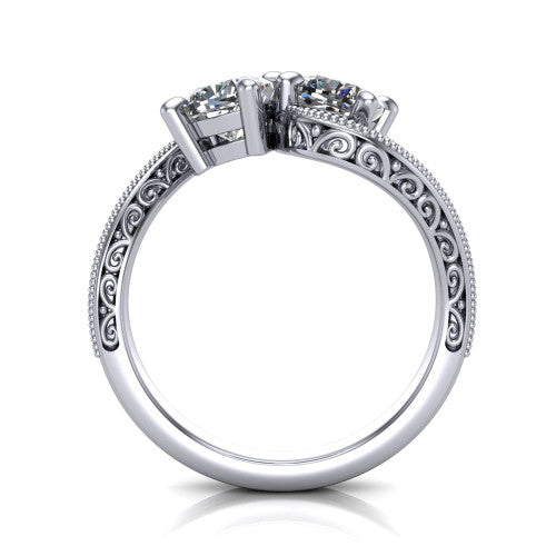 Stevie cushion three stone engagement ring in Platinum, through-finger front profile showing the two-stone head, filigree shoulders, milgrain band edges, and pave center row