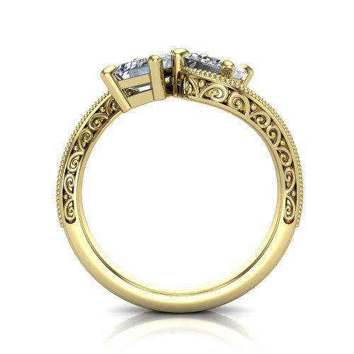 Stevie emerald three stone engagement ring in 14K Yellow Gold, through-finger front profile showing the two-stone head, filigree shoulders, milgrain band edges, and pave center row