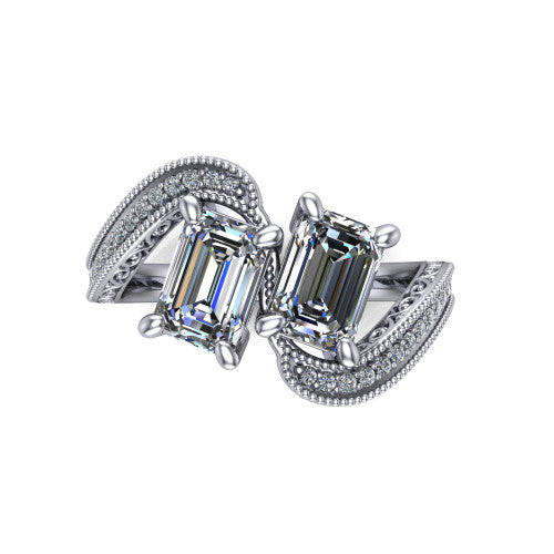 Stevie emerald three stone engagement ring in 18K White Gold, top-down view showing two step-cut emerald diamonds set diagonally in a toi et moi arrangement above filigree scrollwork shoulders and a pave band