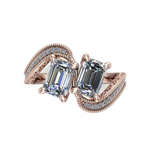 Stevie emerald three stone engagement ring in 18K Rose Gold, top-down view showing two step-cut emerald diamonds set diagonally in a toi et moi arrangement above filigree scrollwork shoulders and a pave band