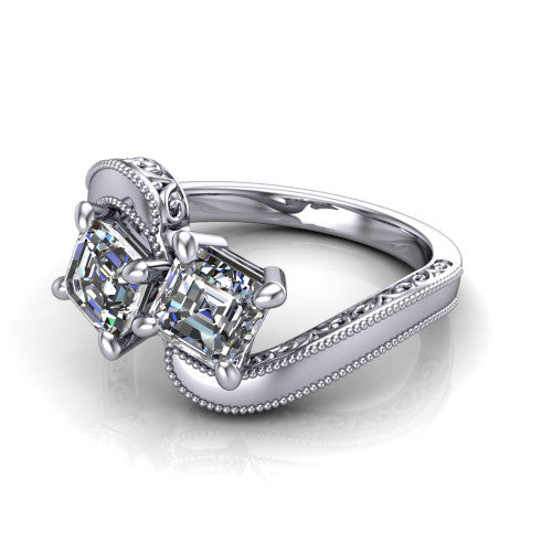 Logan square emerald three stone engagement ring in Platinum, three-quarter perspective showing two step-cut square emerald diamonds set diagonally on engraved filigree shoulders with milgrain edges