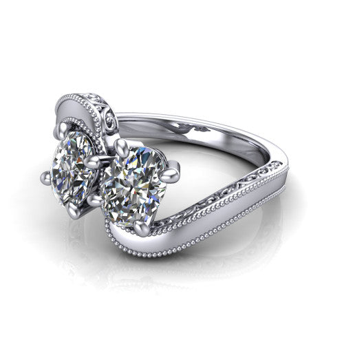 Logan oval three stone engagement ring in 14K White Gold, three-quarter perspective showing two brilliant oval diamonds set diagonally on engraved filigree shoulders with milgrain edges