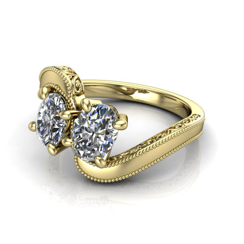 Logan oval three stone engagement ring in 14K Yellow Gold, three-quarter perspective showing two brilliant oval diamonds set diagonally on engraved filigree shoulders with milgrain edges