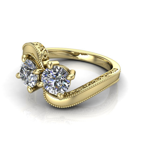 Logan round three stone engagement ring in 14K Yellow Gold, three-quarter perspective showing two brilliant round diamonds set diagonally on engraved filigree shoulders with milgrain edges
