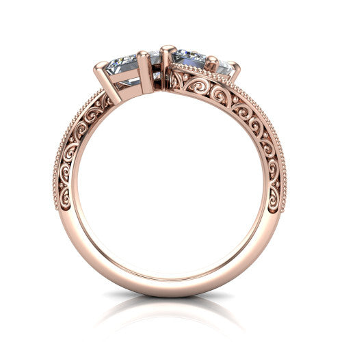 Logan emerald three stone engagement ring in 14K Rose Gold, through-finger front profile showing the two-stone head, filigree scrollwork, and milgrain band edges