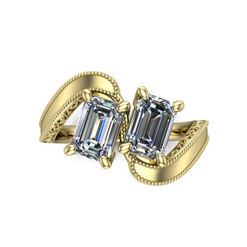 Logan emerald three stone engagement ring in 18K Yellow Gold, top-down view showing two step-cut emerald diamonds set diagonally in a toi et moi arrangement above filigree scrollwork shoulders