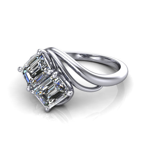 Julianna emerald three stone engagement ring in Platinum, three-quarter perspective showing two step-cut emerald diamonds set diagonally on multi-ribbon wrapping shoulders