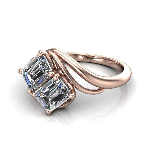 Julianna emerald three stone engagement ring in 18K Rose Gold, three-quarter perspective showing two step-cut emerald diamonds set diagonally on multi-ribbon wrapping shoulders