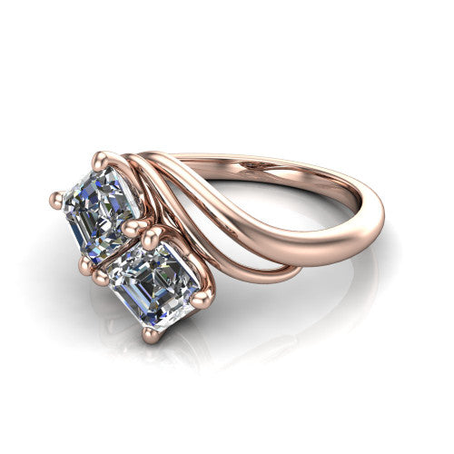 Julianna square emerald three stone engagement ring in 14K Rose Gold, three-quarter perspective showing two step-cut square emerald diamonds set diagonally on multi-ribbon wrapping shoulders