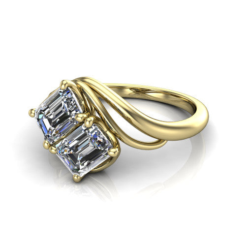 Julianna emerald three stone engagement ring in 14K Yellow Gold, three-quarter perspective showing two step-cut emerald diamonds set diagonally on multi-ribbon wrapping shoulders