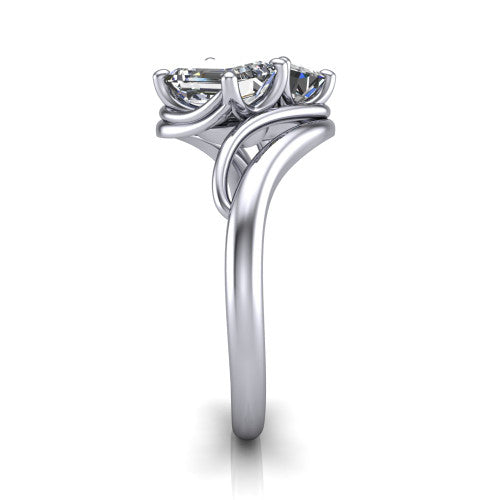 Julianna emerald three stone engagement ring in Platinum, side profile showing the multi-ribbon shoulders curving around the head before rejoining as one band