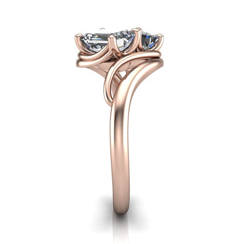 Julianna emerald three stone engagement ring in 14K Rose Gold, side profile showing the multi-ribbon shoulders curving around the head before rejoining as one band