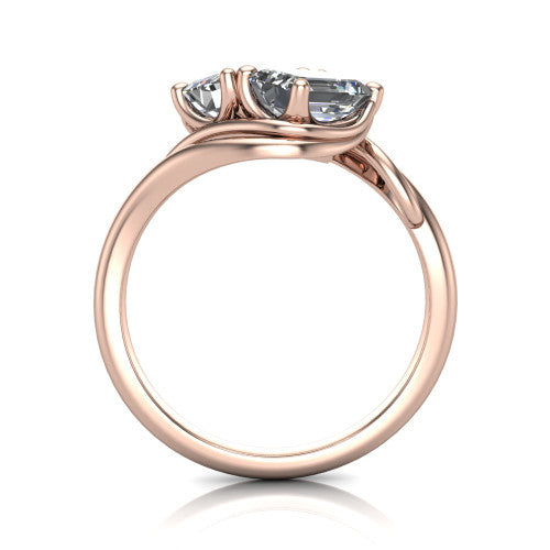 Julianna emerald three stone engagement ring in 18K Rose Gold, through-finger front profile showing the two-stone head and slim plain band