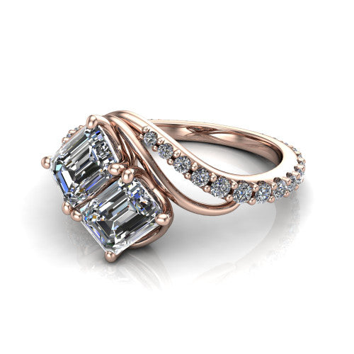 Gwen emerald three stone engagement ring in 18K Rose Gold, three-quarter perspective showing two step-cut emerald diamonds set diagonally on a pave wraparound shank with bypass curving shoulders