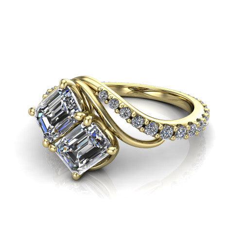 Gwen emerald three stone engagement ring in 14K Yellow Gold, three-quarter perspective showing two step-cut emerald diamonds set diagonally on a pave wraparound shank with bypass curving shoulders