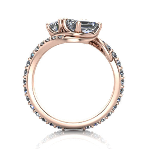 Gwen emerald three stone engagement ring in 14K Rose Gold, through-finger front profile showing the two-stone head and pave wraparound band