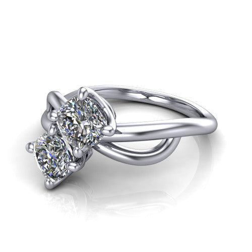 Mya cushion three stone engagement ring in Platinum, three-quarter perspective showing two brilliant cushion-cut diamonds set diagonally on a polished infinity-loop shank