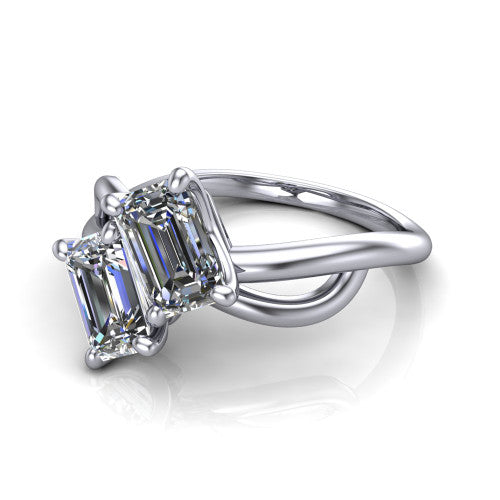 Mya emerald three stone engagement ring in 14K White Gold, three-quarter perspective showing two step-cut emerald diamonds set diagonally on a polished infinity-loop shank